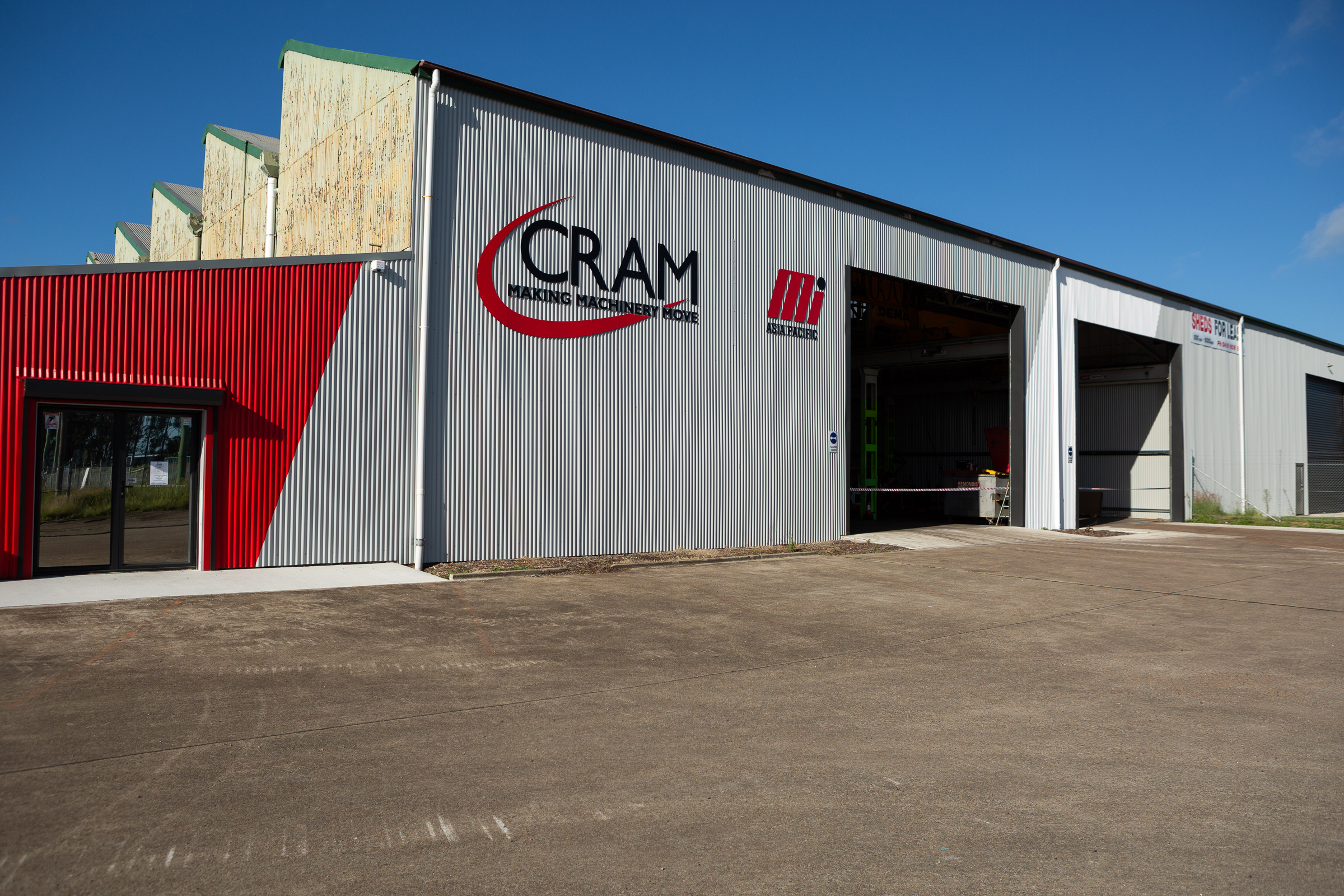 CRAM branded building with CRAM red stripe Cram logo and co-brand Motion Asia Pacific